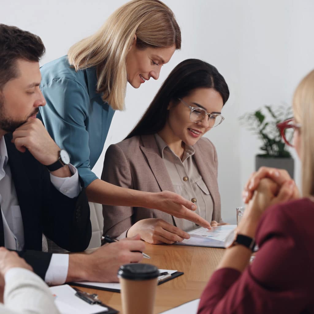Client having meeting with her employees in office